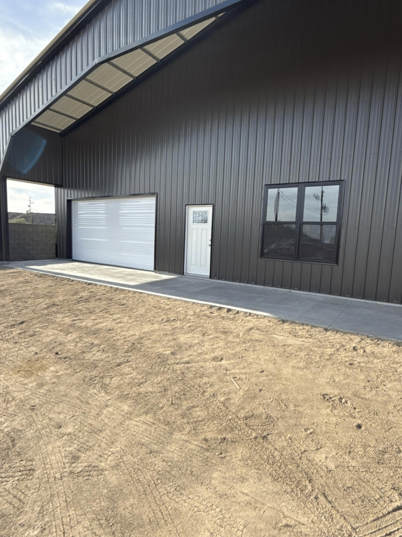 New construction barn-style metal building — exterior service ready