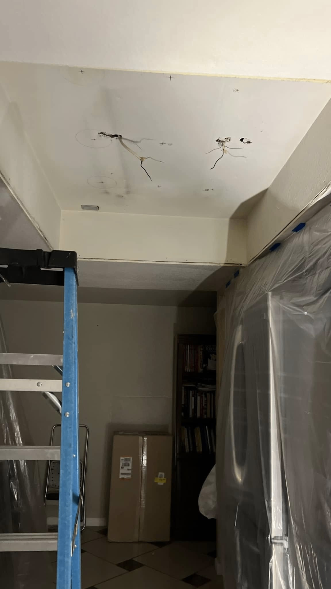 Recessed lighting rough-in — drywall cut, wires pulled and marked